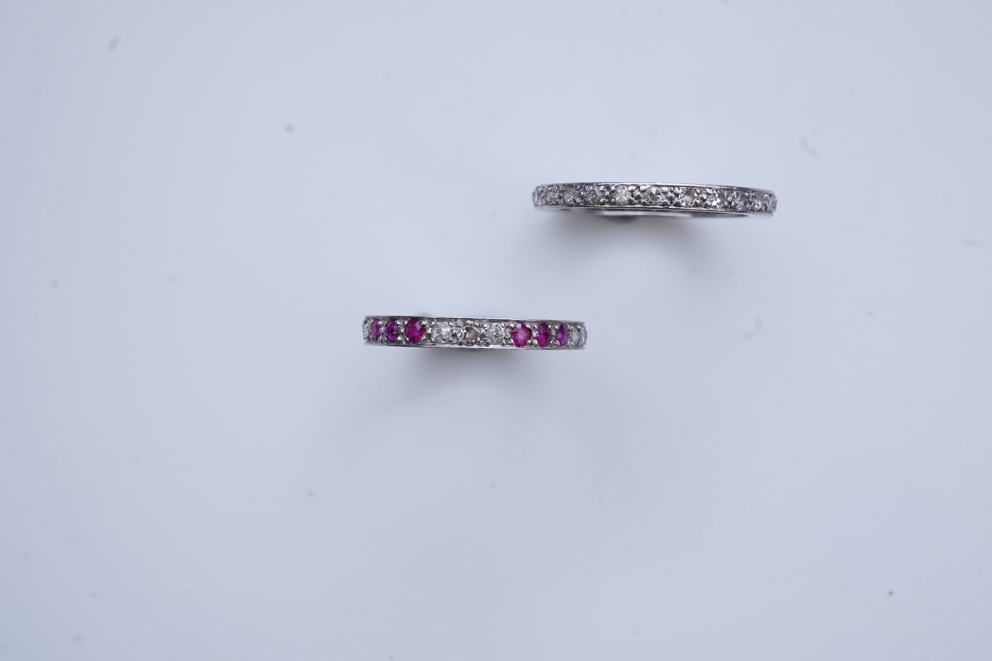 A diamond eternity ring and a ruby and diamond half eternity ring, mid 20th century